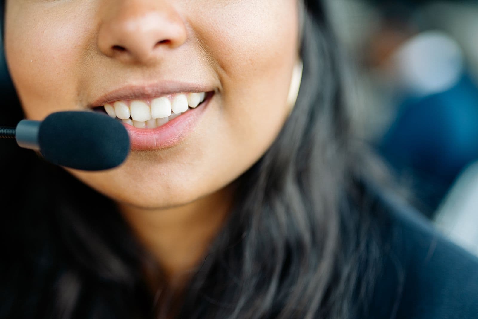 A smiling advisor wearing a headset