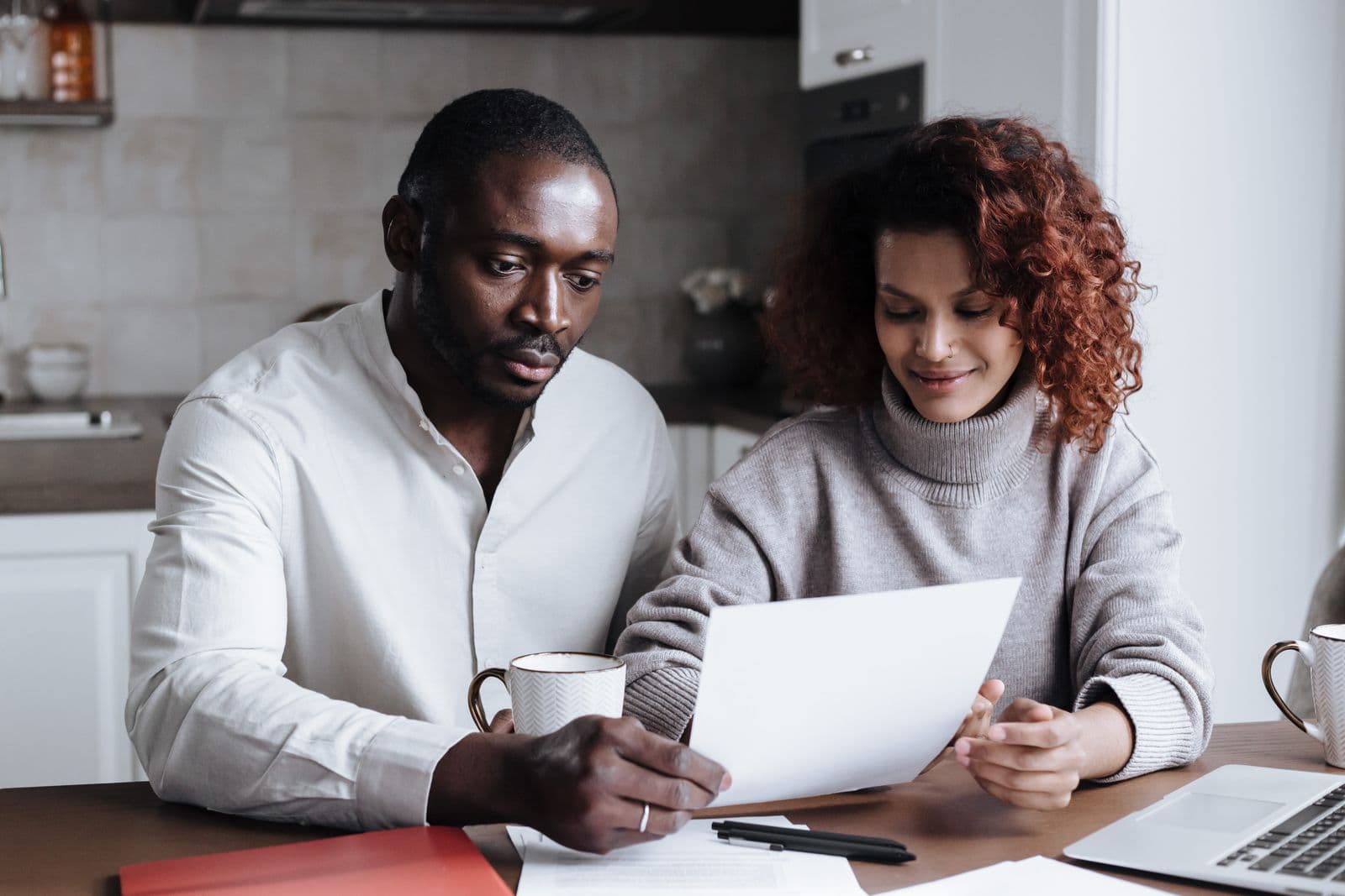 A couple reviewing coverage documents at their kitchen table